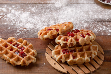 Tasty homemade waffle and strawberry jam