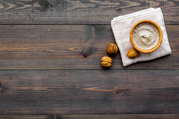 organic scrub with walnut for homemade spa on wooden background top view mockup
