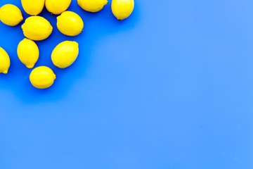 Ripe lemon fruit backround on blue table top view copy space