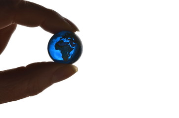 Miniature planet Earth hold protective with two fingers on a white background
