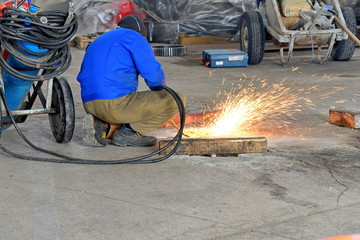 Industrial Worker. Welder-carver at the production of gas-welding with sparks.