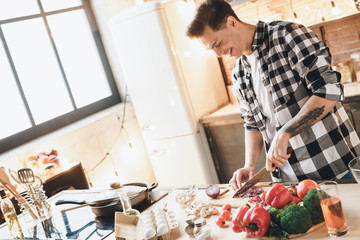Beautiful happiness man making salad at home
