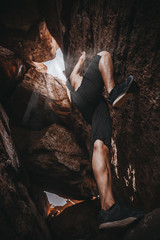 Asian handsome man climbing the cave