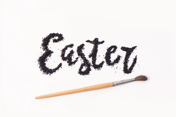 Word Easter from ground coffee with a brush for drawing with space for text 