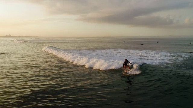 Surfing: Surfer woman riding on the blue waves slow motion