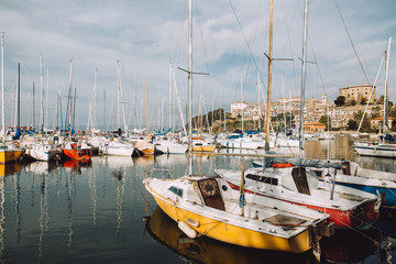 Fototapeta na wymiar Mirror image of the boats in a marina in italy