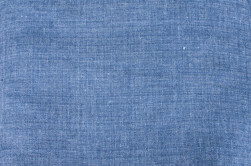 Texture of denim blue linen flax fabric closeup as textile background