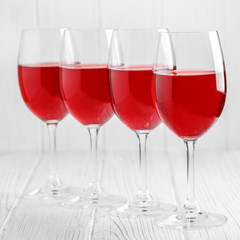 Many glasses of burgundy French wine on a wooden table. Concept