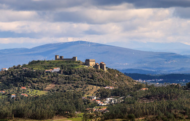 Landscape with ourém castle and mountains in background on a cloudy spring day, in Portugal. -...