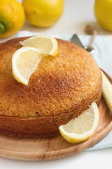 Lemon lavender cake and lemons on a light background. Rustic style.