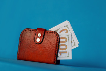 money in a red purse on a blue background