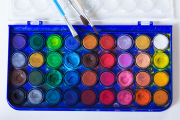 set of watercolor paints with brushes