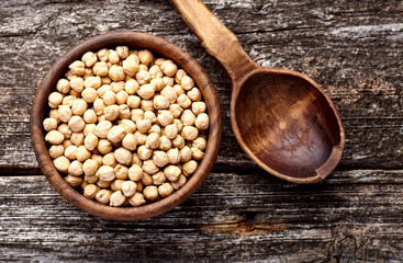 Chickpeas in wooden  bowl on wooden background.