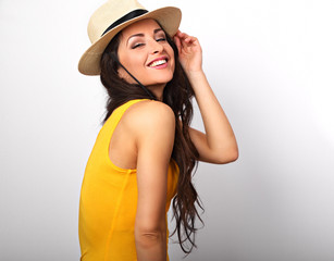 Beautiful long hair laughing woman in yellow top and straw hat looking happy with toothy smiling