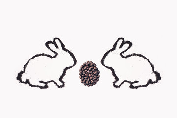 Easter bunny from coffee ground with egg on a white background