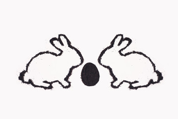 Easter bunny from coffee ground with egg on a white background