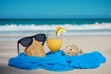 coconut, cocktail and glasses by the ocean