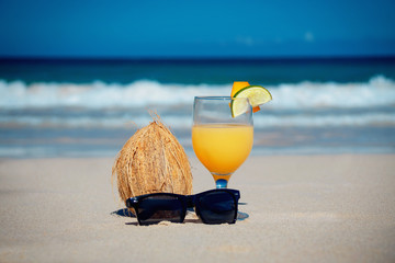 coconut, cocktail and glasses by the ocean