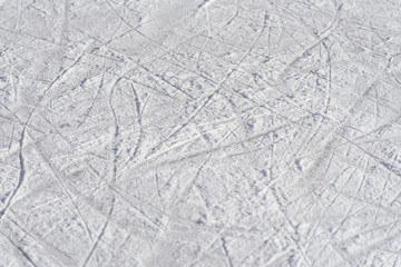 traces on the ice from skates on the rink