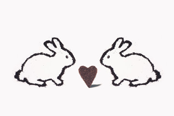 Two Easter bunny from coffee ground with huge heart cookie on a white background