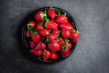 Strawberry. Fresh strawberry on black background with copy space for text. Heap of Red strewberry...