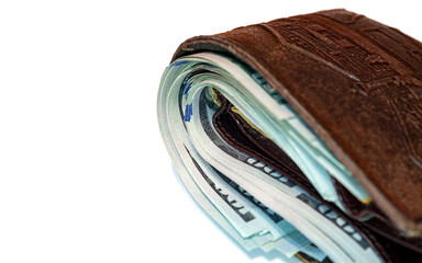 Wallet full of 100 us dollar bills in cash.