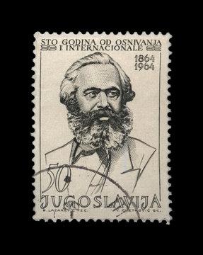 Karl Marx (1818-1883), famous politician leader, circa 1964. canceled vintage postal stamp printed in Yugoslavia isolated on black background. 