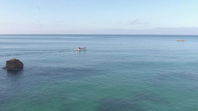 Aerial view of a boat floating in the ocean