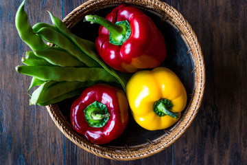 Red and Yellow Pepper with Green Runner Beans in Wooden Basket.