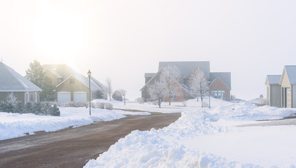 Fog rolling in on a North American residential neighborhood in winter.