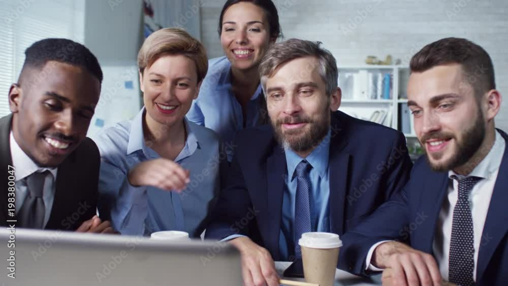 Poster tracking shot of group of colleagues having video conference on laptop computer and smiling