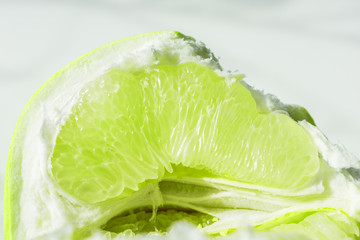 lime slice, slice of green lime orange pamela. Fresh citrus on white background
