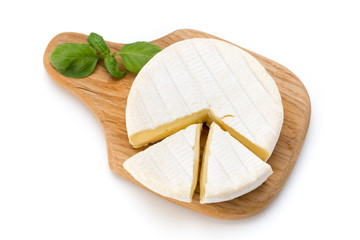 Piece of camembert cheese isolated on white background. From top view.