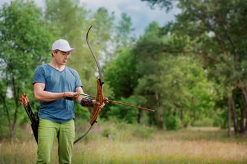 Man shoots an arrow in the forest on vacation