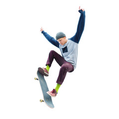 A teenage boy in a hat and a sweatshirt jumping with a skateboard does a trick on an isolated white...
