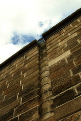 Old brown stone wall with ladder to the sky