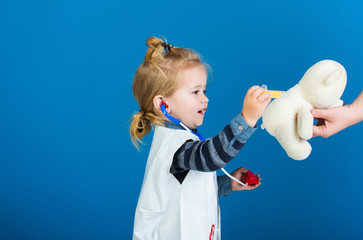 Boy cure toy pet with vaccine on blue background