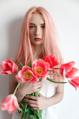 Portrait of a girl with pink hair pink spring flowers