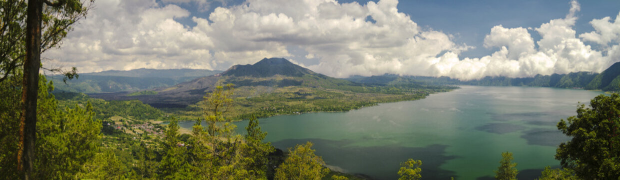 Panorama of Mount Batur Volcano in Kintamani, Bali, Indonesia. Lake Batur is on the southeastern side of the volcano. The lake is 16 kilometres wide and is a popular fishing spot.