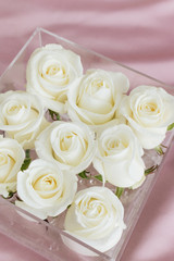 Beautiful spring bouquet with white roses in glass box, elegant floral decoration