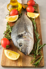 Fresh Raw Dorado with lemon, thyme, cherry and rosemary .