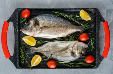 Fresh Raw Dorado with lemon, thyme, cherry and rosemary .