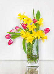 Spring and Easter flowers arrangement with daffodils and red tulips.