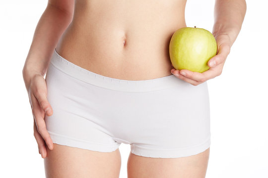 close up of wellness female body holding a green apple