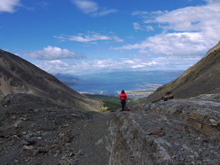 A young girl stops to admire the view of Ushuaia near the summit of Martial Glacier