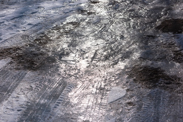 Naklejka premium Ice, mud, tire marks on the road