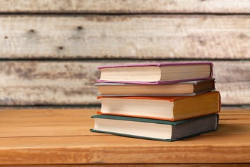 Stack books on wooden desk