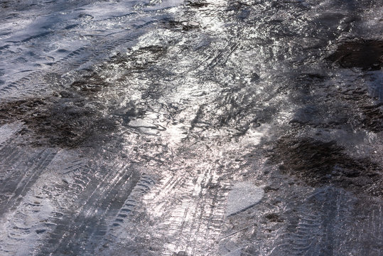 Ice, mud, tire marks on the road