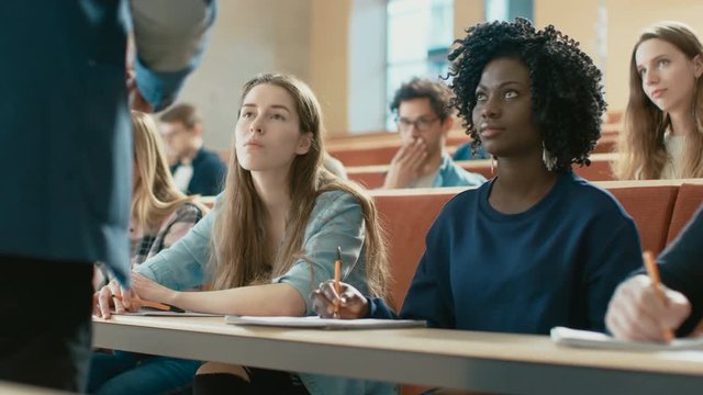 Professor Reads Lecture to a Multi Ethnic Group of Students. Smart Young People Studying at the University. Shot on RED EPIC-W 8K Helium Cinema Camera.