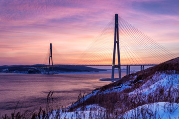 Winter sunset view of long cable-stayed bridge in Vladivostok, Russia